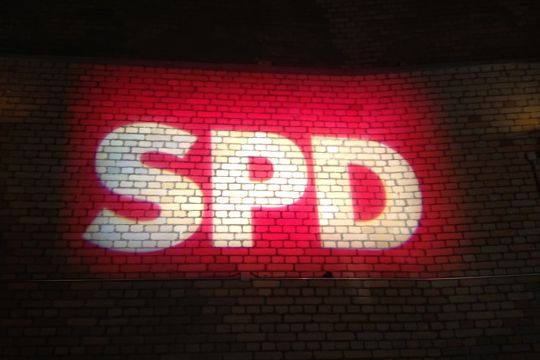 Logo der SPD auf Backsteinwand projiziert