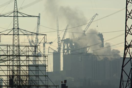 Das Bild zeigt ein Kohlekraftwerk. Im Vordergrund stehen Hochspannungsleitungen.