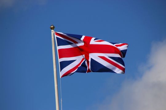 Die britische Flagge weht im Wind vor blauem Himmel