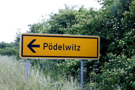 Hier ist ein Straßenschild zu sehen, das zu dem Dorf Pödelwitz führt