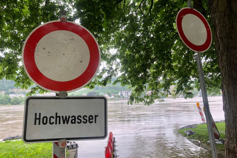 Schilder warnen in einem Überflutungsgebiet vor dem Hochwasser.