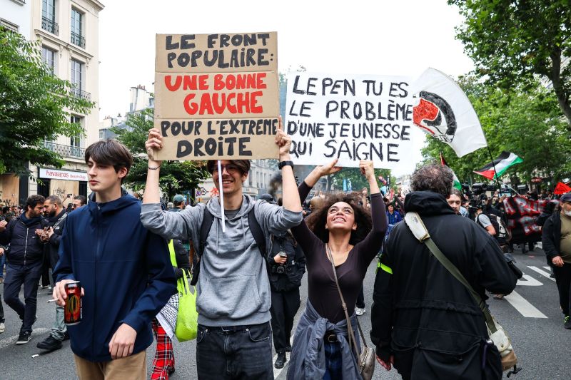 Demonstration mit handgemalten Schildern, auf denen in Französisch steht: Die Front populaire, eine gute Linke für die extreme Rechte.